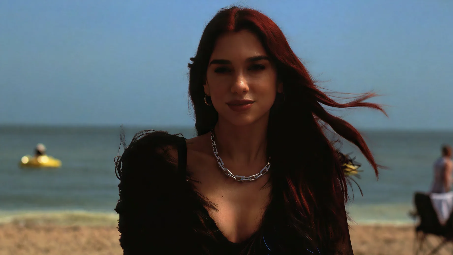 Dua Lipa on a windswept beach in the O2 advert