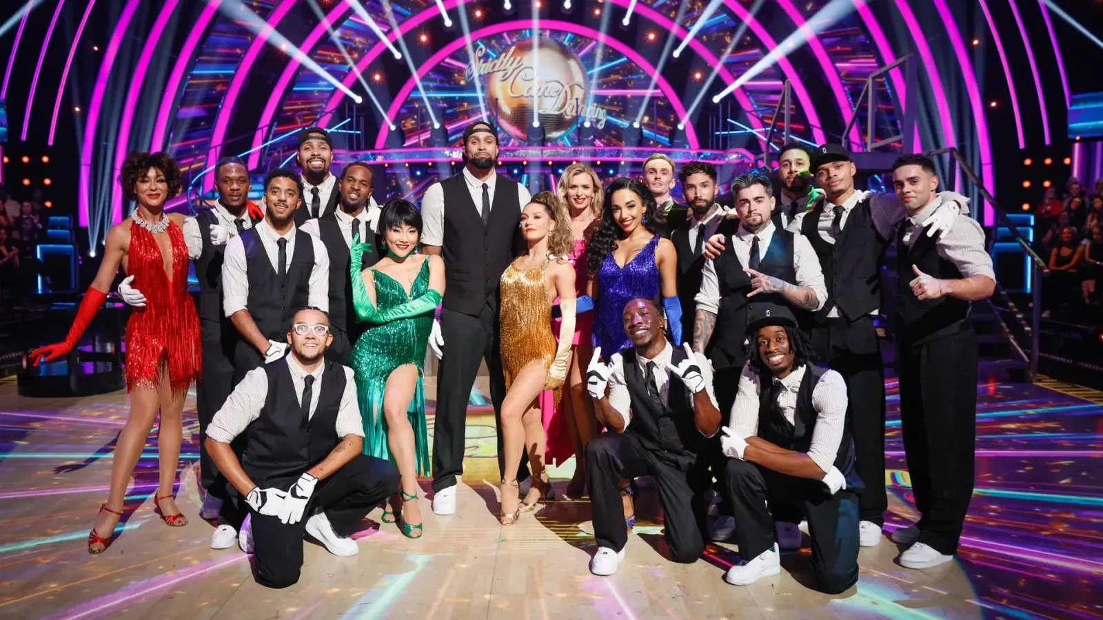 Strictly Come Dancing professionals in waistcoats, caps and sequins posed on the dance floor