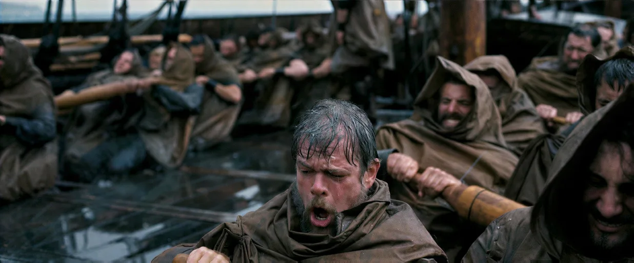 Rowers in soaked capes hauling on their oars in driving rain, in The Odyssey